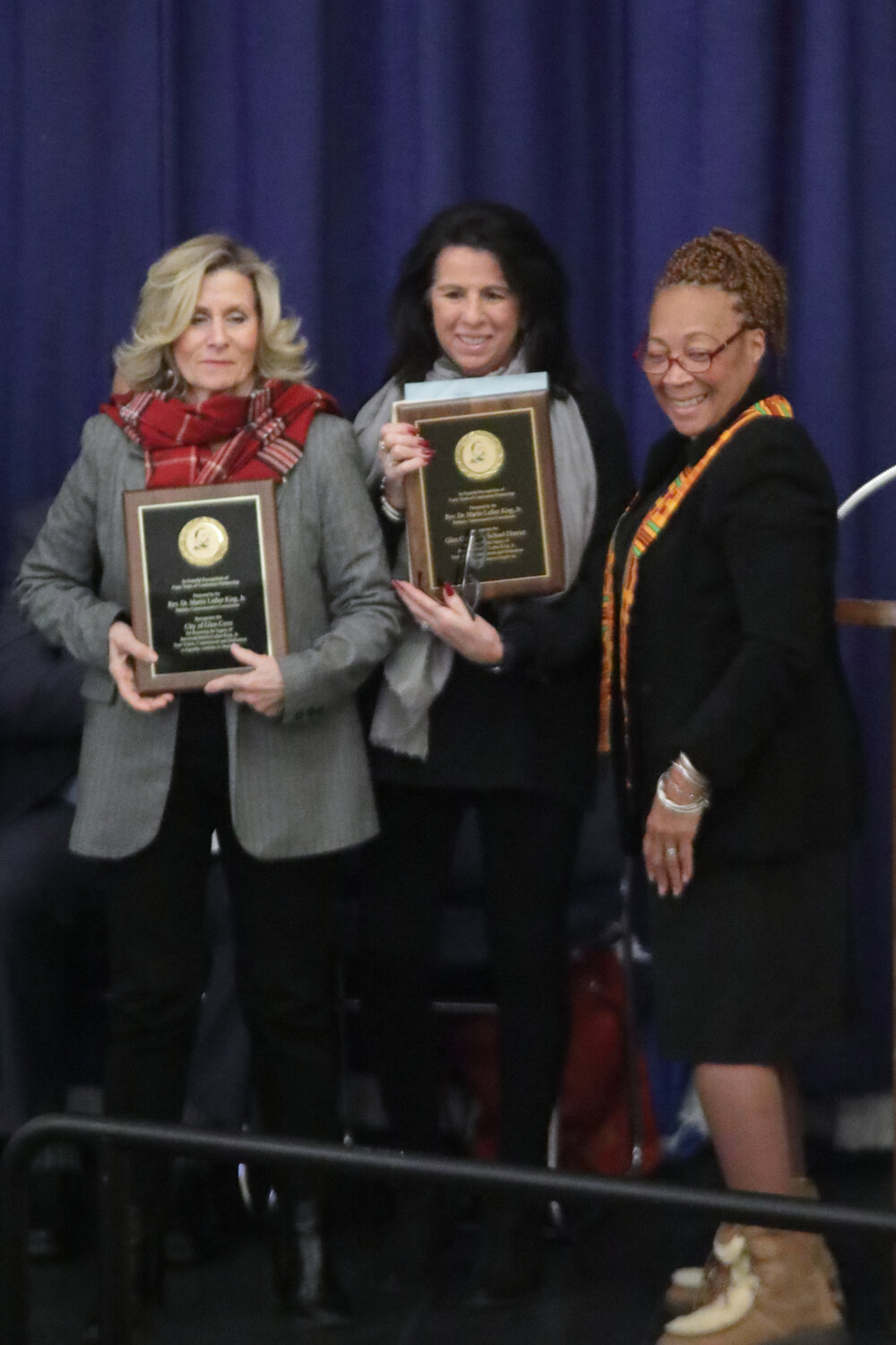 Sheryl Goodine, mistress of ceremonies, presents awards to Mayor Pamela Panzenbeck and Maria Rianna, superintendent of Glen Cove City Schools.