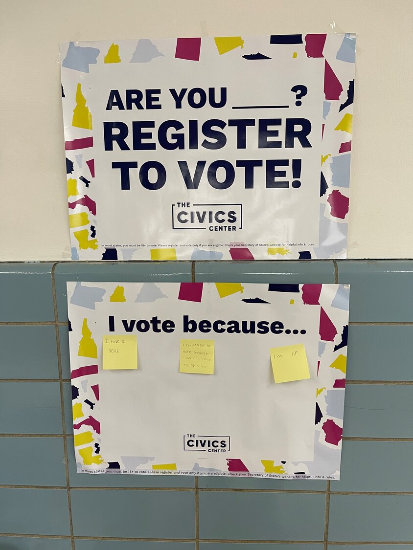 During the voter registration drive at Sanford H. Calhoun High School run by the Racial Equity Club, students shared why they vote on Post-it notes, which they stuck on a poster.
