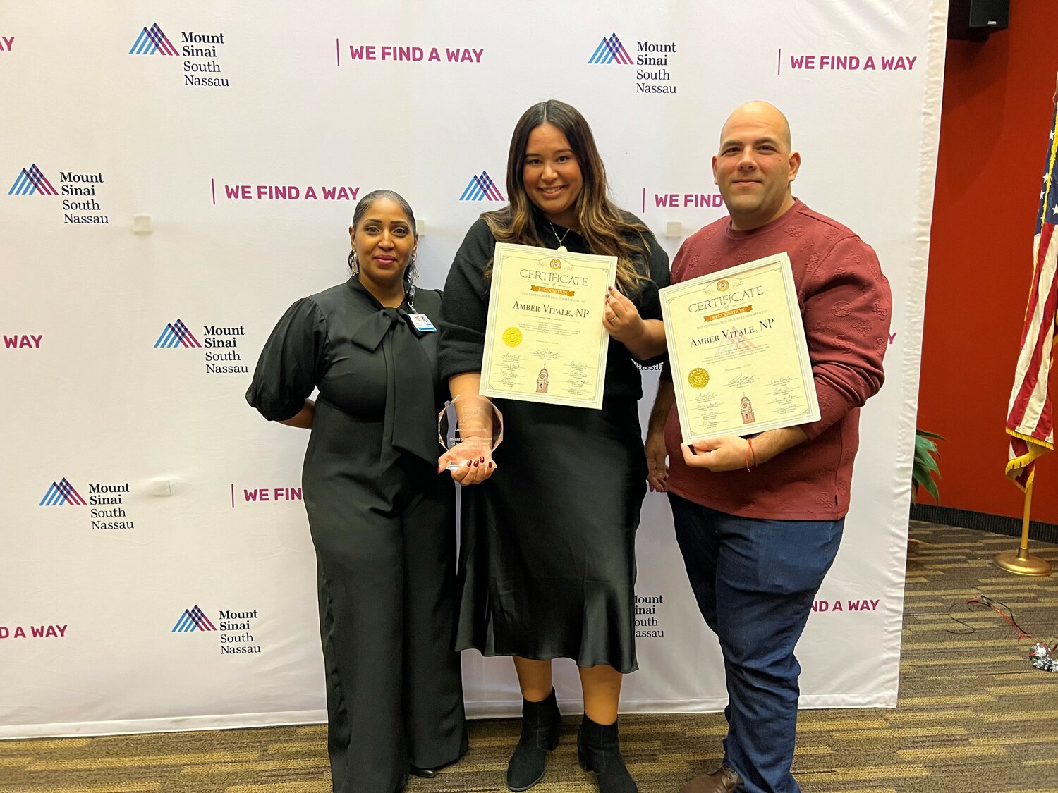 Karine Austin, assistant vice president and chair of Martin Luther King Jr. committee at Mount Sinai South Nassau, left, with Amber Vitale and her husband Joe Vitale proudly showing off commemorative plaque/glass emblem for being presented MSSN Martin Luther King Jr. Service award.