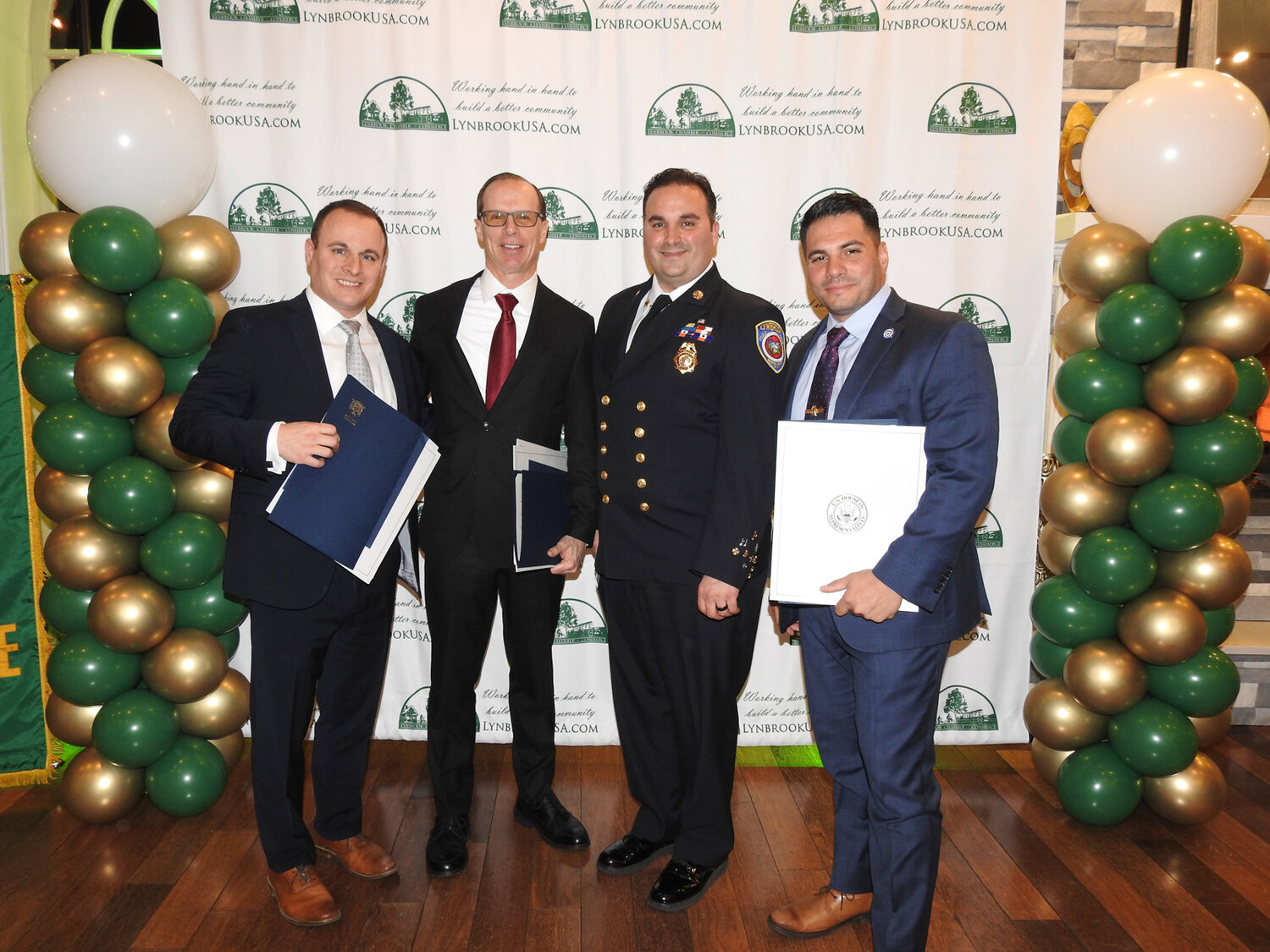 Lynbrook Chamber of Commerce honorees, from left, Benedict Tieniber, Educator of the Year; Chris Anderson, owner of Crown Ford; Chris Kelly, former chief of the Lynbrook Fire Department; and Lt. Anthony Falsitta, of the Lynbrook Police Department.