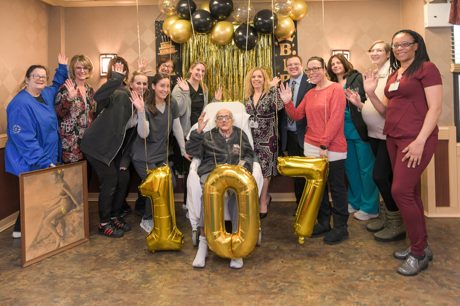 Family, friends and staff members at the Rockville Skilled Nursing and Rehabilitation Center celebrate Kenneth Neilson’s 107th birthday.