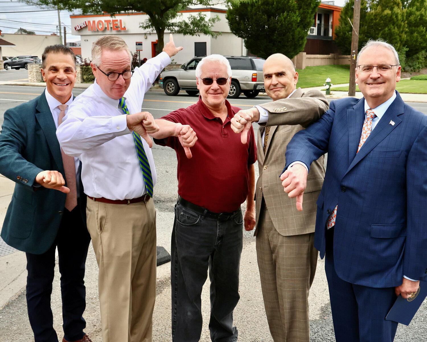 Hempstead Town Supervisor Don Clavin, along with Councilman Tom Muscarella, left, and Nassau County legislators Bill Gaylor and John Giuffré, call for the Capri Motor Inn in West Hempstead to be closed. To do that, however, Muscarella’s colleagues on the town board first had to declare the Hempstead Turnpike inn a public nuisance.