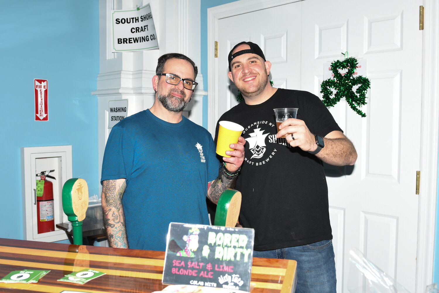 Dan Landerer, left, manager of the South Shore Craft Brewing company in Oceanside and Brew Master Pete Tripp celebrate with a toast.