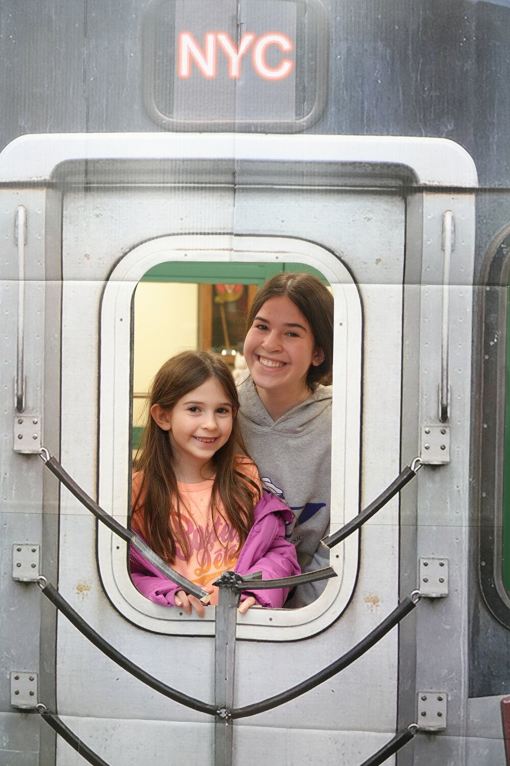 Amelia Faynberg, a second-grader at Hewlett Elementary School with her sister Rebecca Faynberg, a Hewlett High junior, take a ‘ride’ on the city subway.