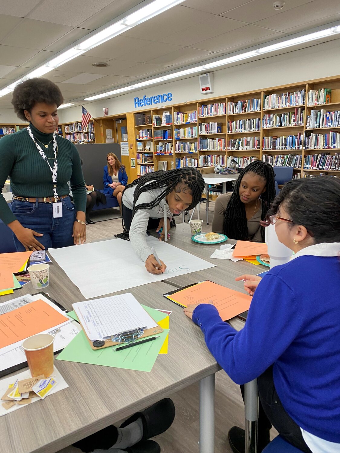 Students from both Malverne and Uniondale teaming up and gathered around their table to collaborate on policy that would improve the conditions of where they live.