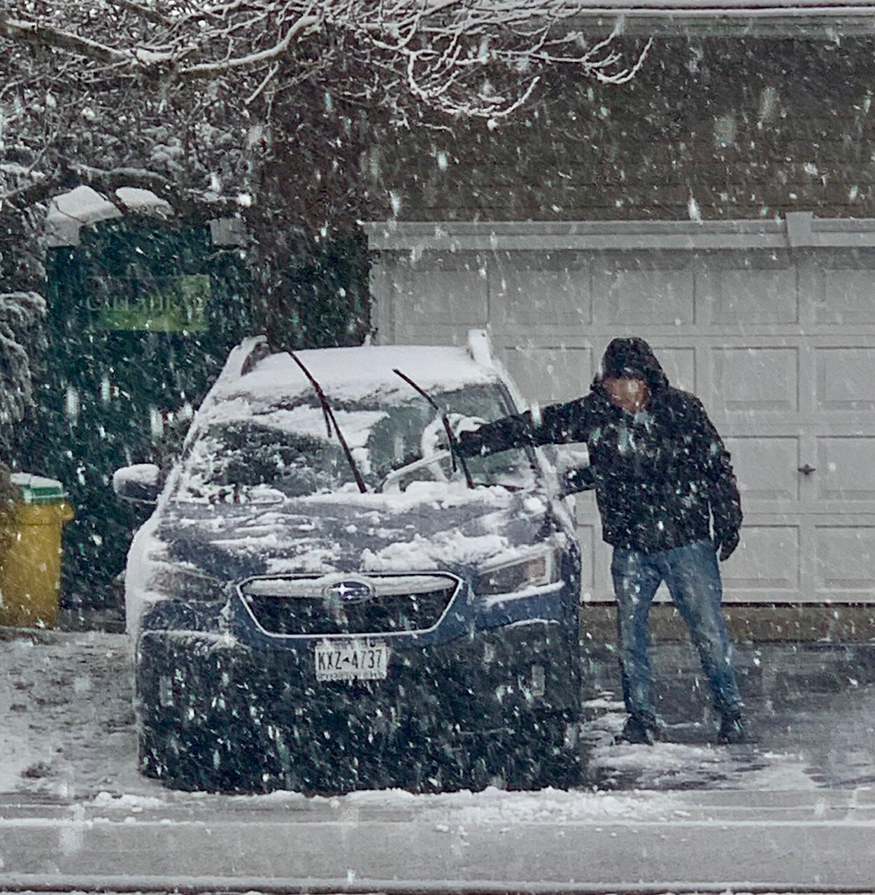 Marty King cleans off his vehicle on Cedarhurst Street in North Woodmere.