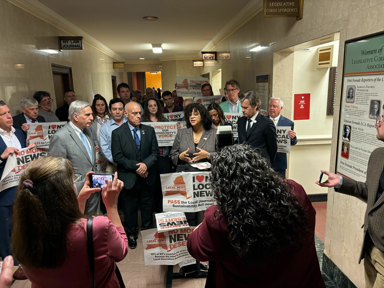 Assemblywoman Michaelle Solages joins lawmakers and supporters like Assemblyman David Weprin, at left, and state Sen. Brad Hoylman-Sigal, at right, to call on her colleagues to support the Local Journalism Sustainability Act. The measure — currently included in the senate’s One House budget — would provide tax credits to local news outlets, so they can keep local reporters on the ground and covering communities.