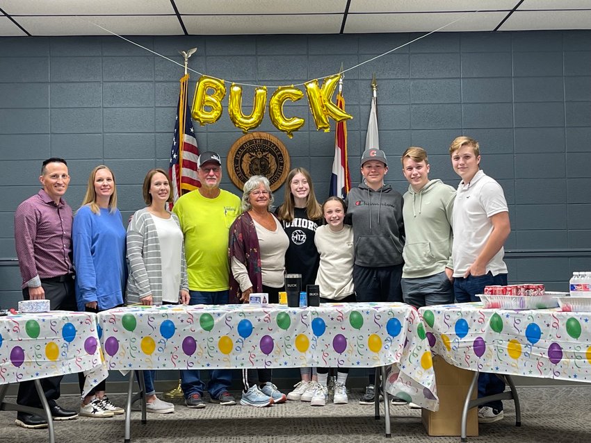 &quot;Buck&quot; in yellow with his family at his retirement party.