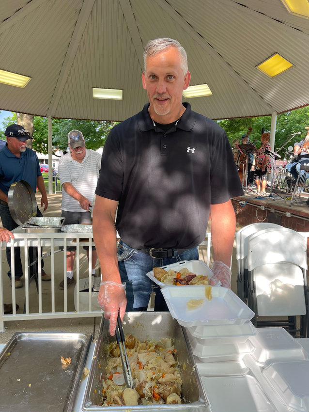 &ldquo;Guy&rdquo; serves food to hungry patrons at the Trash Can Feed on June 4 in Seymour. Plates were $10 each and benefited the King&rsquo;s Food Pantry. 50lbs each of potatoes, carrots, onions and cabbage, along with corn and sausage made up the meal cooked by The Masons.