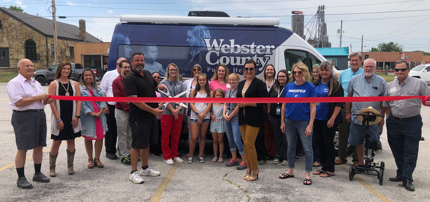 Staff from the Webster County Health Unit along with Marshfield Area Chamber of Commerce Board members and others from the community gathered around to perform the &ldquo;ribbon cutting&rdquo; ceremony for the Webster County Health Unit&rsquo;s new mobile unit on Thursday, July 7.&nbsp;