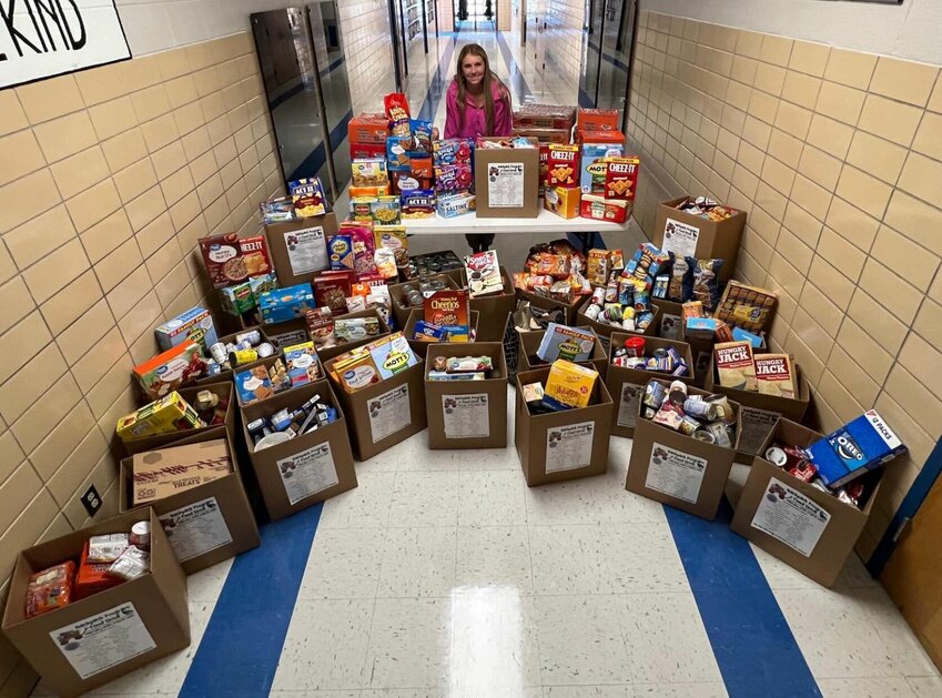 MHS Senior Riley Manary, for her senior project, set up a food drive competition for the students of Webster and Shook Elementary that would benefit Marshfield's backpack program for two weeks. When the contest ended, over 7,500 non-perishable food items were donated, ensuring many fellow students would not go home hungry.   Contributed Photos by Julie Manary.