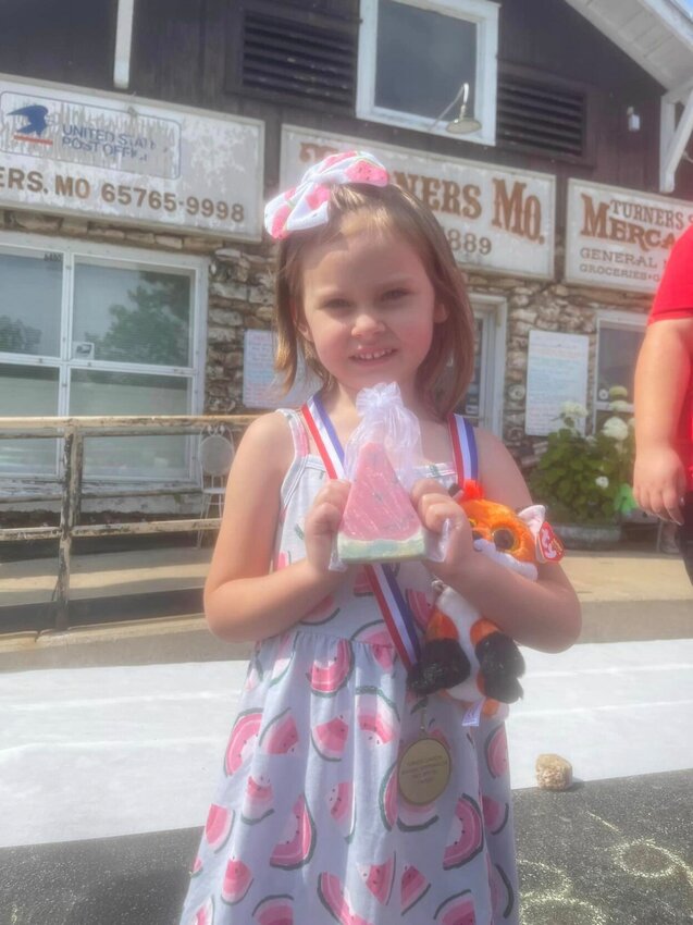 Toula, age 5, was proud of her medal and watermelon slice soap prize after winning her age category.&nbsp;   Mail Photos by Shelby Atkison