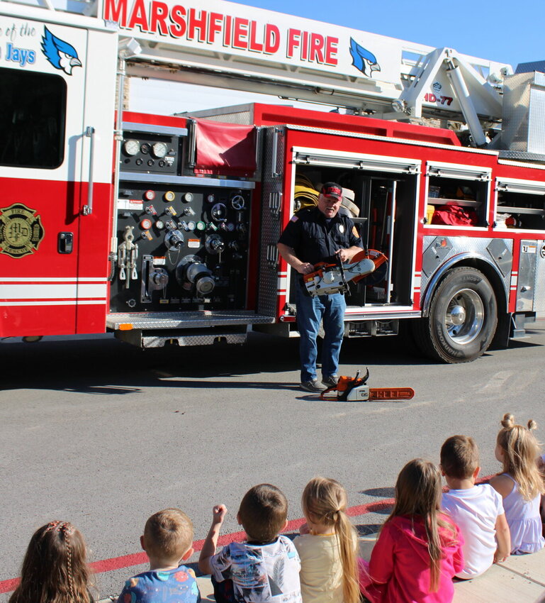 The students of the Marshfield Early Learning Center &quot;saw&quot; a lot of cool things a firefighter gets to use as Senior Firefighter Mark Heil goes over some of the equipment inside the fire trucks of the Marshfield Fire Protection District.   Mail Photos by J.T. Jones