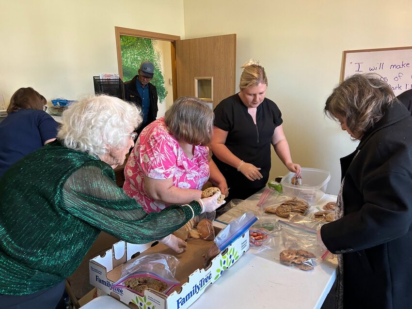 Carol Larimore, Dianna Witte, Sarah Inman, and Margo Delgado sort, bag, and box cookies at the Elkland Independent Methodist Church. Sunny Fuller and Chuck Witte work in the foreground. The cookies were then sent to the soldiers at the USO at Fort Leonard Wood.   Contributed Photo