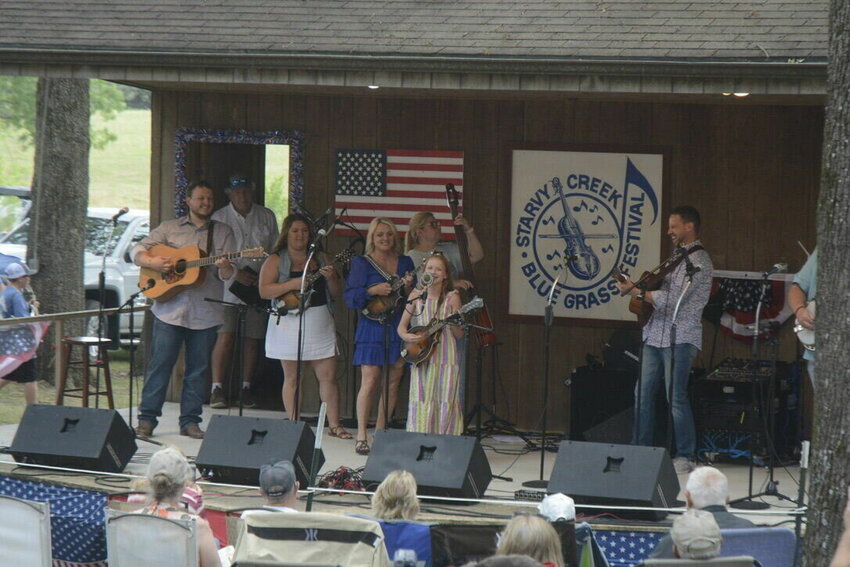 Rhonda Vincent joins a young bluegrass artist onstage during last year's July festival at Starvy Creek in Conway.&nbsp;&nbsp;Mail File Photo