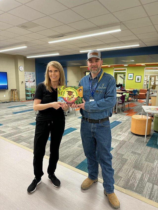 Jason Duncan is pictured with Fordland librarian Mrs. Tricia Farnsworth as he shared the accurate agriculture story &quot;Right this Very Minute&quot; with elementary students.   Contributed Photos