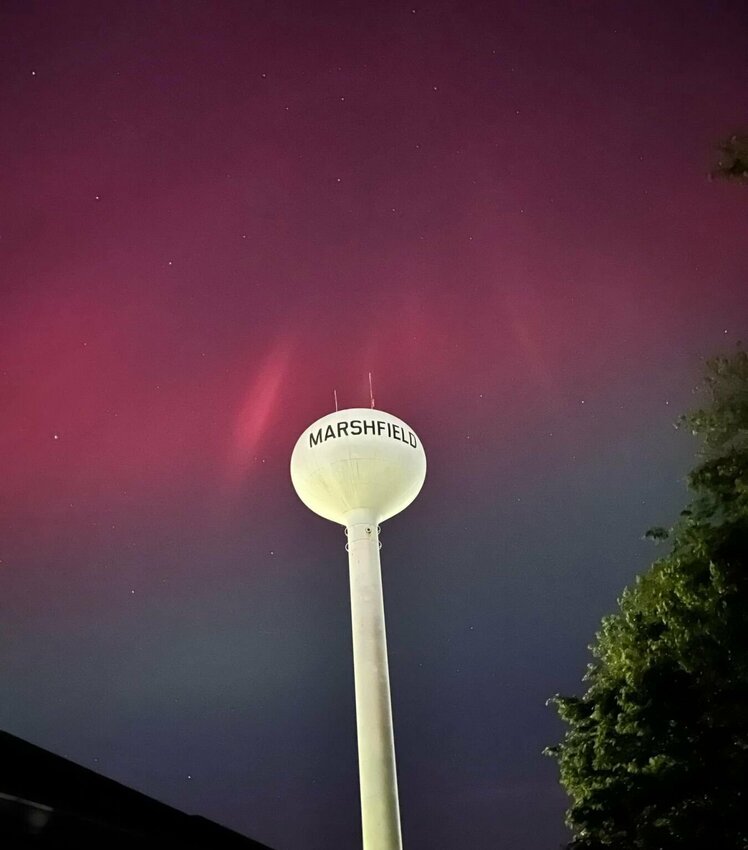 The aurora borealis beam around the Marshfield watertower Friday night.&nbsp;   Contributed Photo by Sarah Kelley