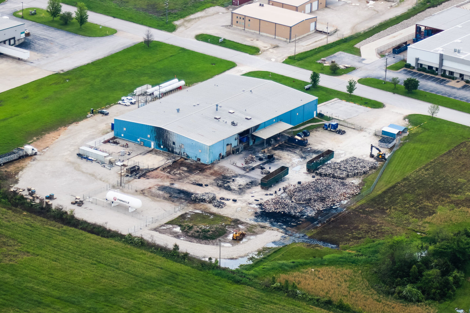 The aftermath of the fire at the Kosan Crisplant/McKeen site on South Prairie Lane. The report details two burned semi-trailers and a a freight vehicle.