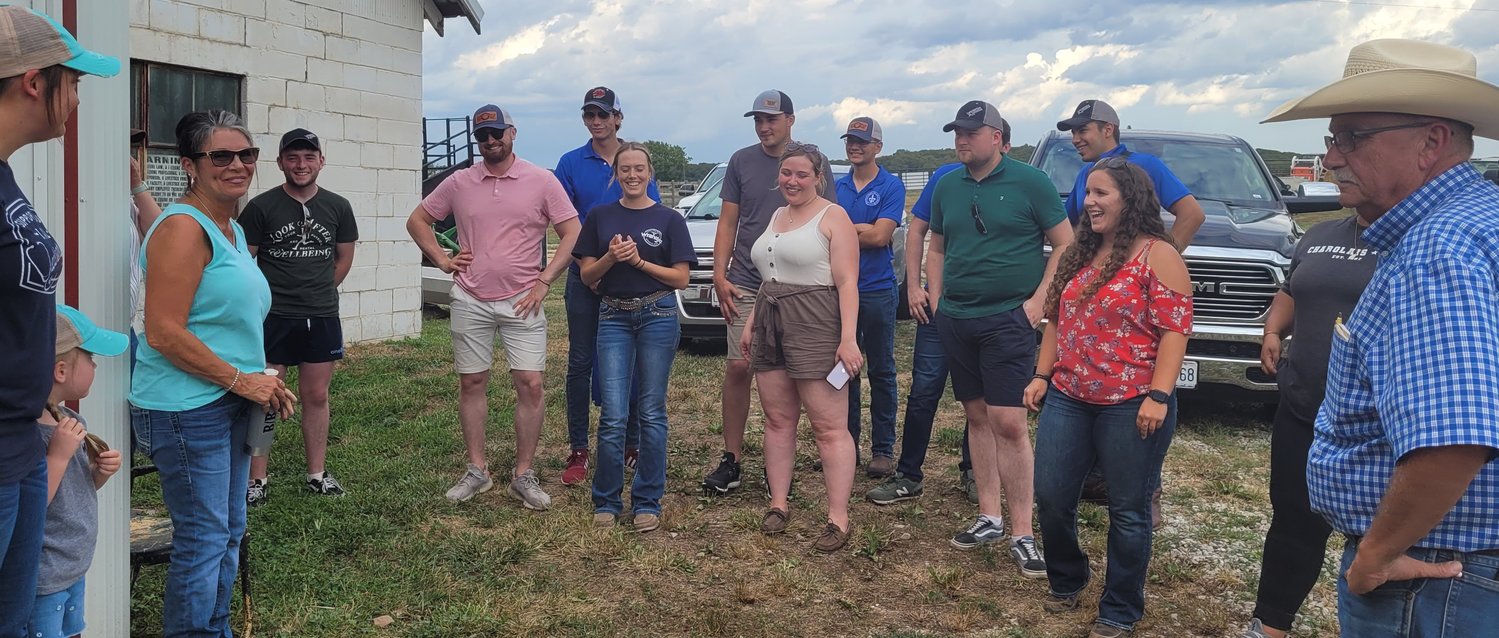 Bruce and company greet the American-International Junior Charolais Foundation group representatives. This was their second day traveling all over Missouri to see how farmers here take care of their Charolais Cattle.