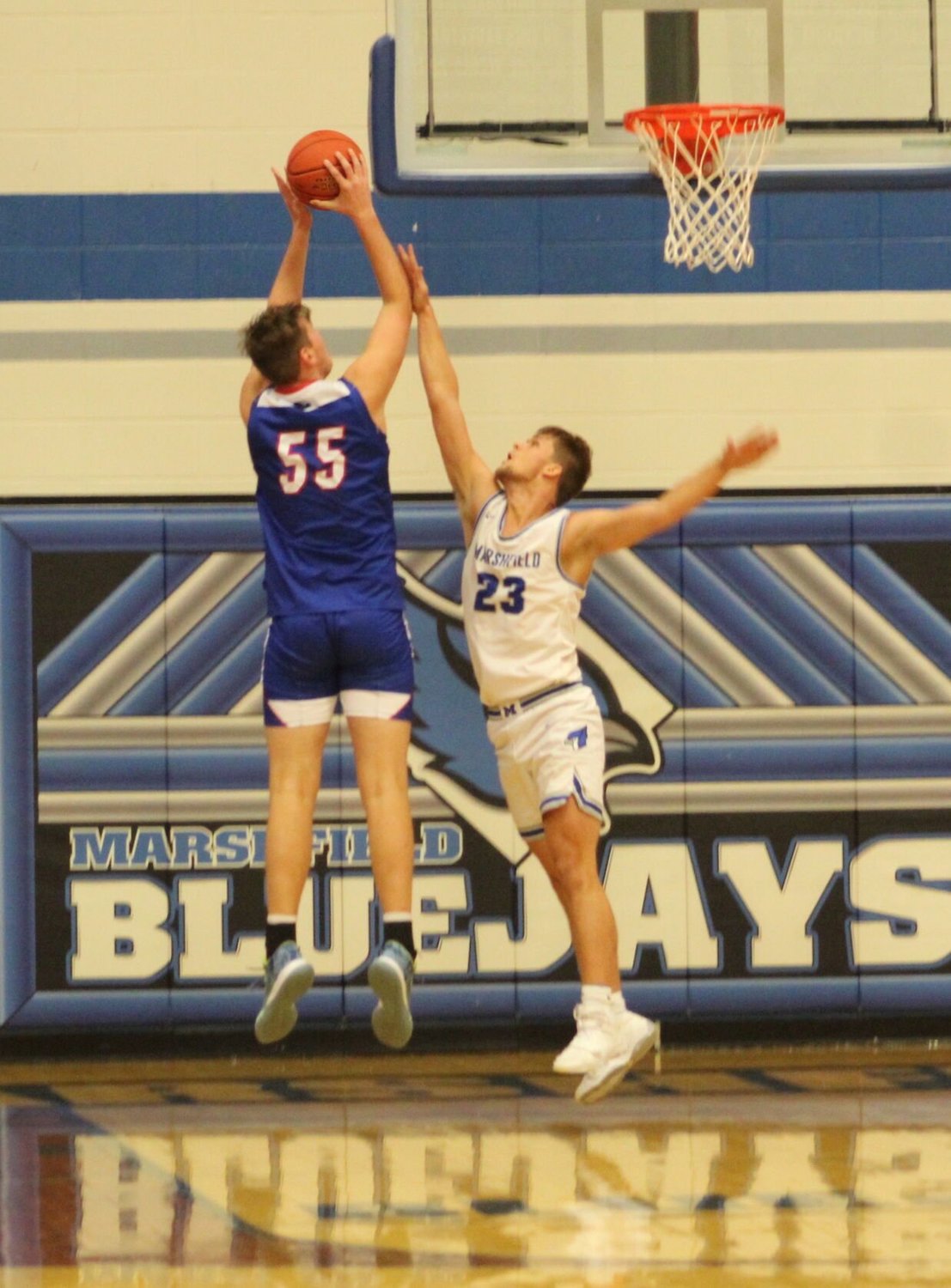 Jumping up to block a shot is Senior Zack Mings.
