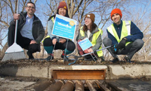 (L&gt;R) City Council Member Andrew Johnson with drain adopters Mandy LaBreche and Jillian Kaster are joined by Minneapolis Public Works Engineer Bryan Dodds at the 10,000th drain adopted by Mandy.