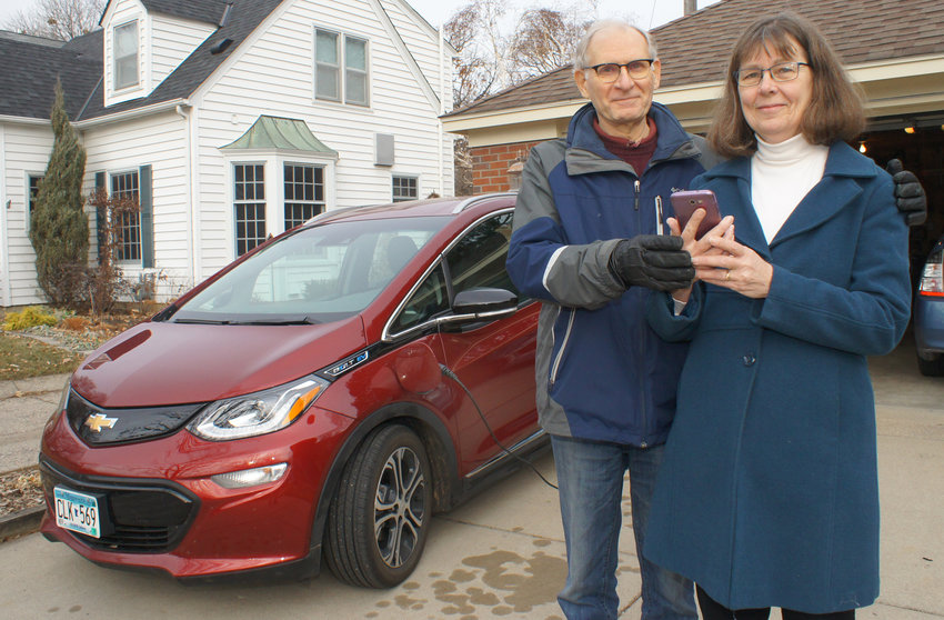 Rod Johnson and Kathy Hollander love their Chevy Bolt. The charging unit plugs into a standard 110 volt wall outlet, and then the charging plug fits into a port on the outside of the car. Using the ChargePoint app, users can monitor the Bolt's charging progress while away from the car. The Bolt can go about 240 miles on a full charge. (Photos by Terry Faust)