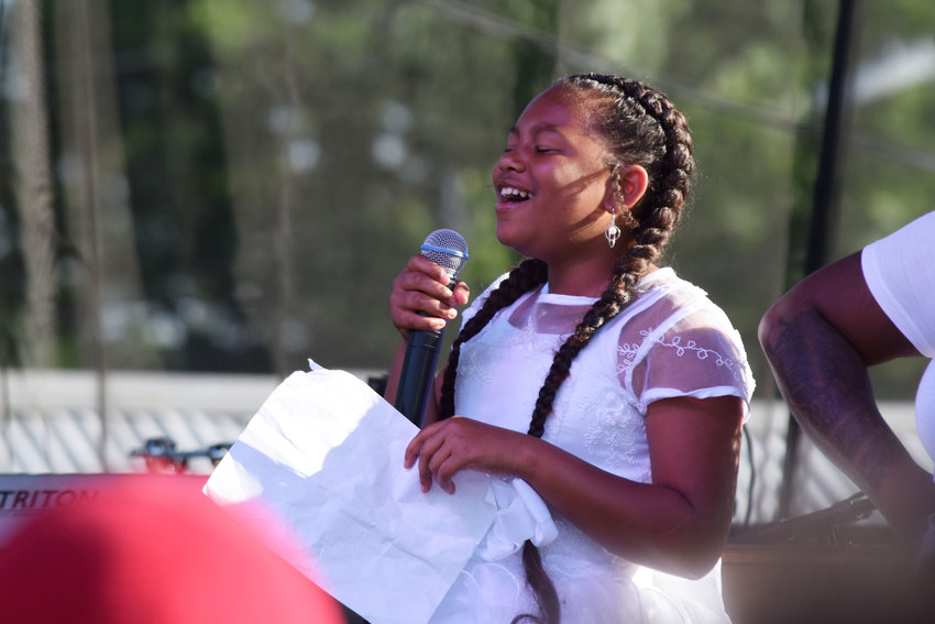 At eleven years old11-year-old community member Innocynce sings &ldquo;Lift Every Voice and Sing,&rdquo; the Black national anthem, before the Concert Honoring Families of Injustice or Loss at the Rise &amp; Remember event on May 25th at George Floyd Square. Youth entrepreneur Innocynce also helps run the D.I.H. (Do It Herself) Positive Corner booth at events.