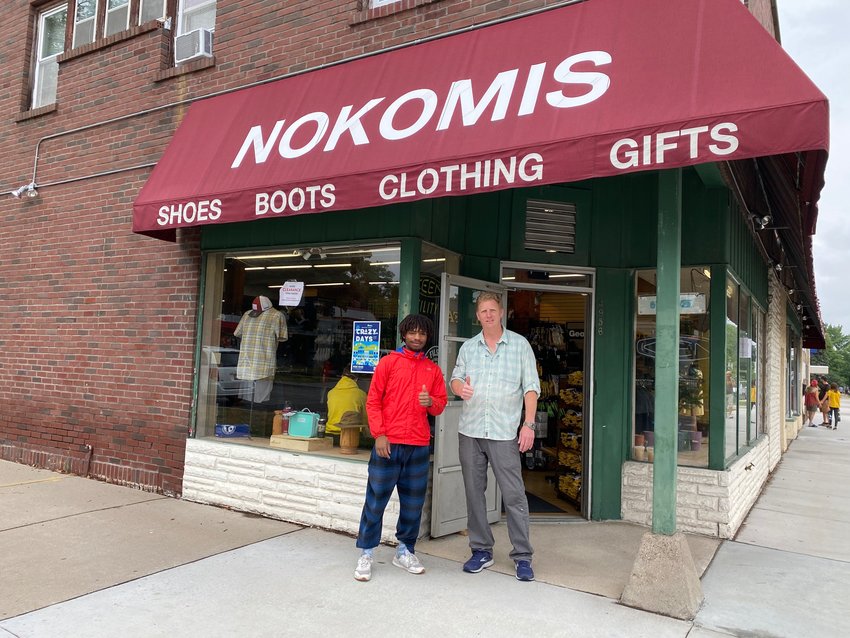 Nokomis Shoe Shop owner Steve Negaard (right) with Tre McClellan welcome folks into the store for the sidewalk sale, which moved instead after it rained on Saturday, Aug. 7. Negaard was delighted to see other business engaging in Crazy Days again. &quot;As a guy who has been doing it for 45 years, it's so fun to see the neighborhood coming back alive,&quot; he said. Nokomis Shoes used to be located next to the bowling alley (formerly Skylanes, now Town Hall) and items filled the sidewalk in front of the bowling alley. &quot;I remember being a kid in high school and dreading working the long days in the heat,&quot; said Negaard.