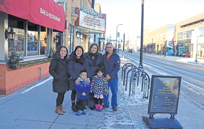 Amazing Thailand has struggled without street parking for customers in front of their building at 3024 Hennepin Ave. S., especially as they’ve shifted business to takeout, says general manager Korawan (Yin) Muangmode, second from left, shown with her brother and family,  owners Dee and Kulsatreet Noree with Yindee and Sandee (age 4), and head chef Khamsouk Pathilath (left).  (Photo by Tesha M. Christensen)