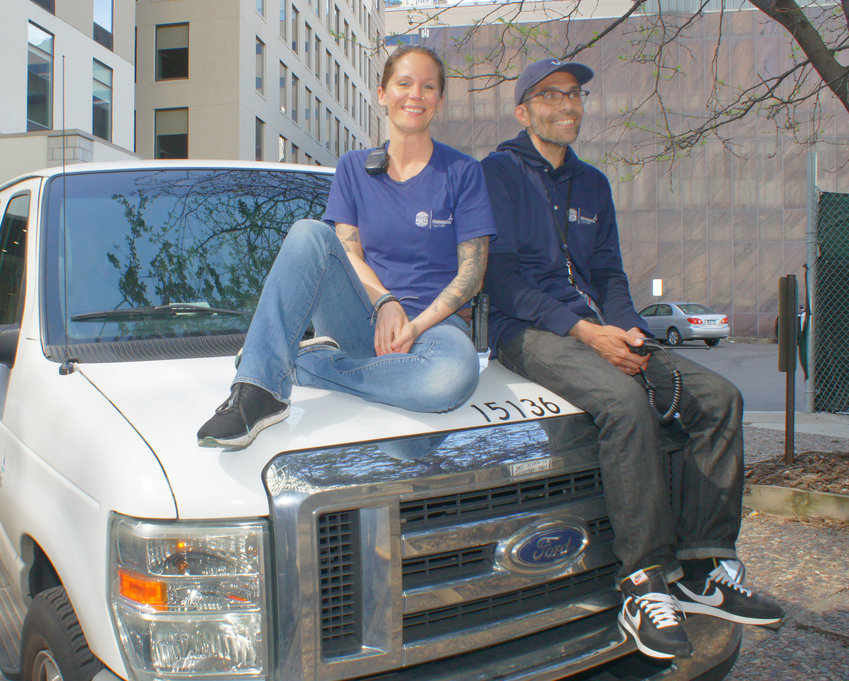 Crisis Responders Amy Brueckner (left) and Dean Zoller pose on one of the two BCR vans. The vans do not use bright lights or sirens. Responders wear navy blue shirts or jackets with &quot;Behavioral Crisis Response&quot; printed on the back. Responders are not armed, and seek to calm the situation. They maintain kindness and respect. They help the person in crisis and provide resources for further support. (Photo by Terry Faust)