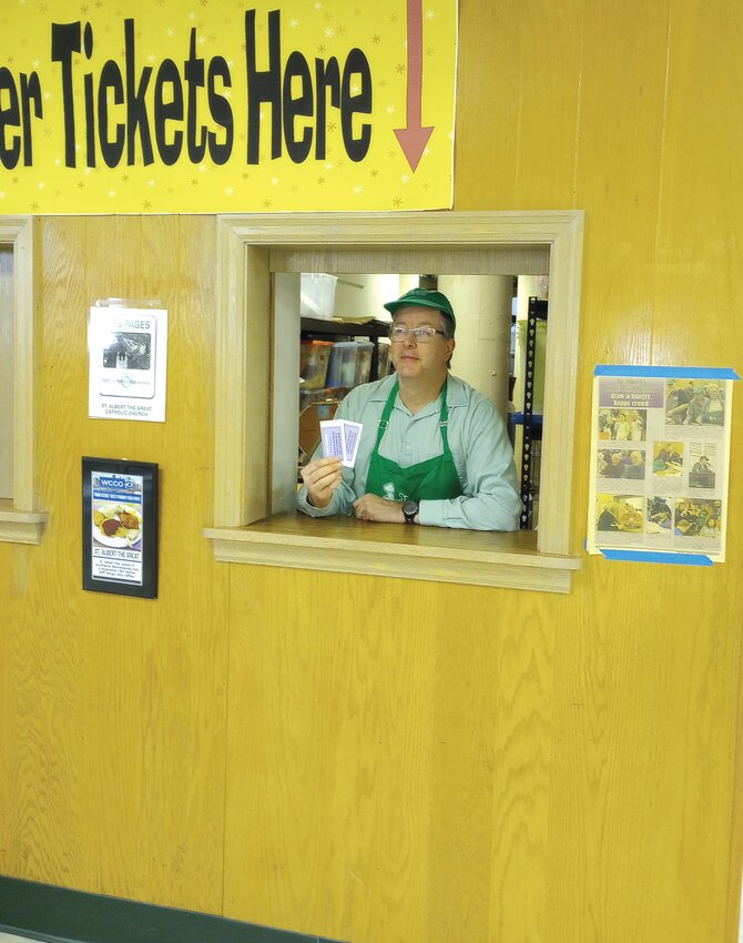 Edward Burke sells tickets at a Church of St. Albert the Great annual fish fry. It returned for six Fridays in Lent after a hiatus due to COVID-19.  (Photo submitted)