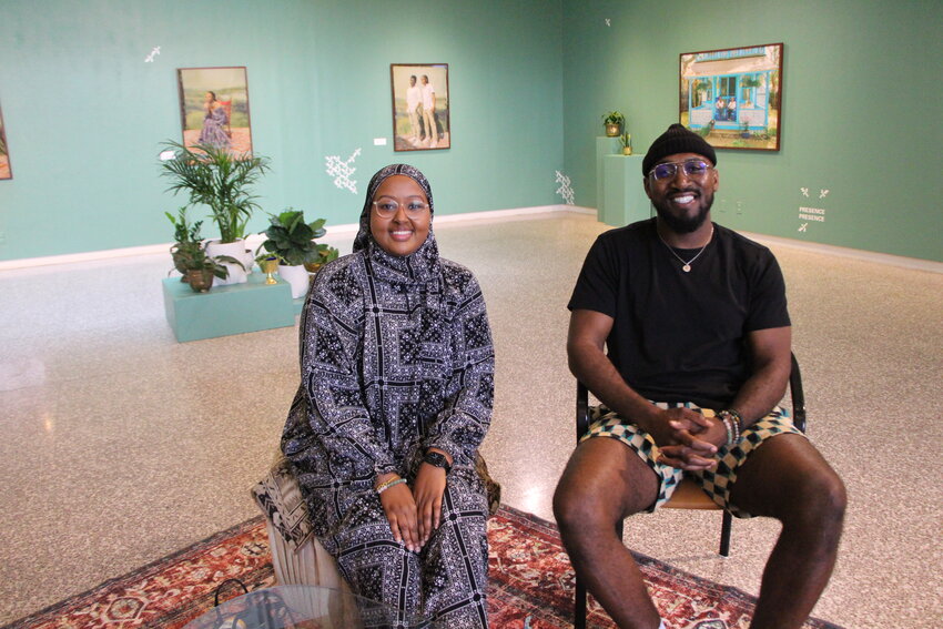 Artists Fadumo Ali (left), and Bobby Rogers (right) sit in the MCAD gallery space of the &ldquo;Grow As We Are&rdquo; art exhibition. It is open through the end of the day on Aug. 5.
