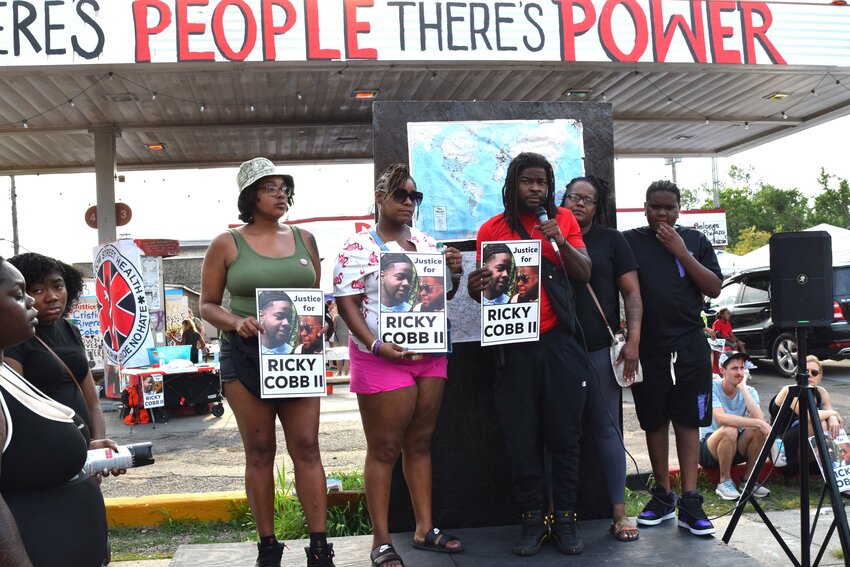 Rashad Cobb (holding microphone) stands with family in grief over the loss at the hands of state troopers of his twin brother, Ricky Cobb II. &ldquo;What are we gonna do for us, as citizens, together&hellip;? I&rsquo;m a peaceful person. I don&rsquo;t really agree with violence.&rdquo;