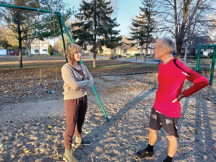 Lisa Priest (left) and Bill Baldus chat about the future of the playground at the closed Cooper school. Priest lives within two blocks of the school and her children play there regularly. She started PlayMPLS to save the playground and has lots of ideas on how that could happen.