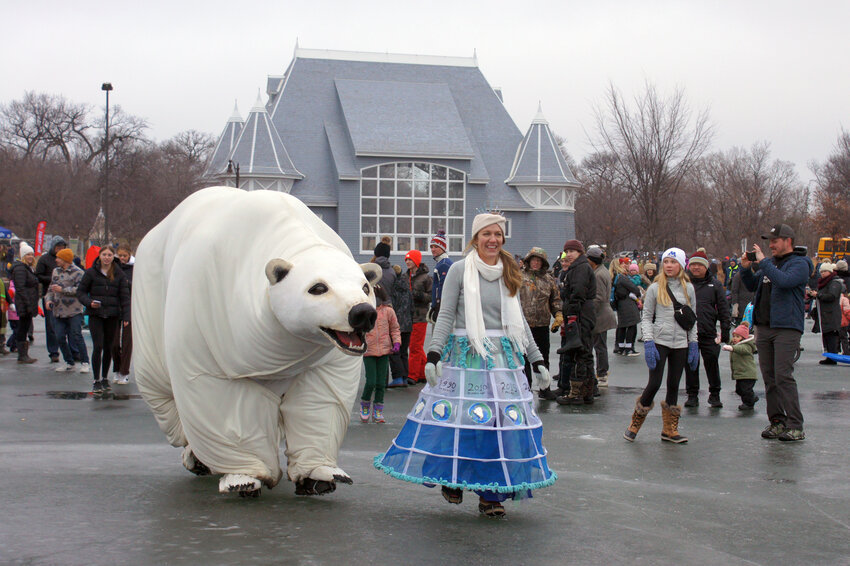 Lady Bear with her human pal, Meg Juedes, were a popular team on the ice during the Ice Shanty Projects at Lake Harriet on Saturday, Jan. 27, 2024. The bear got into roaring contests with fest-goers. Juedes’ dress showed the decline of the polar ice cap by year.