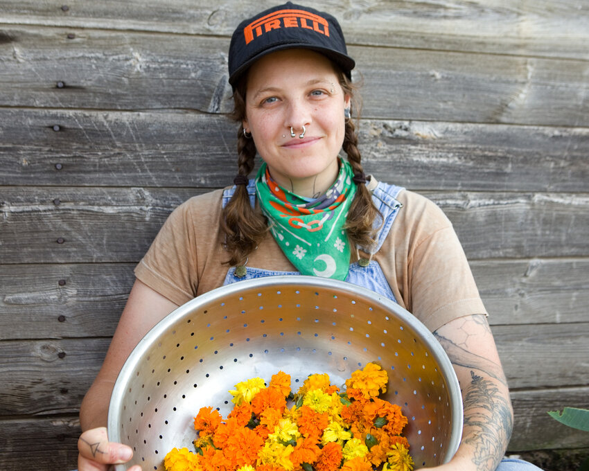 Holding harvested marigold blossoms, farmer and educator Maddy Bartsch said, “We’re land stewards really, those of us who are working to develop our local fiber system.”