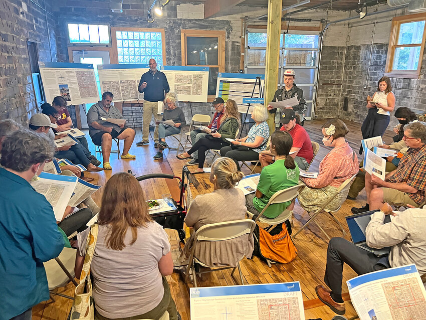 Participants at the fifth city visioning workshop on Sept. 24, 2024, review materials in a breakout room addressing reconstruction of the right of way at 38th St. and Chicago Ave., George Perry Floyd Square.