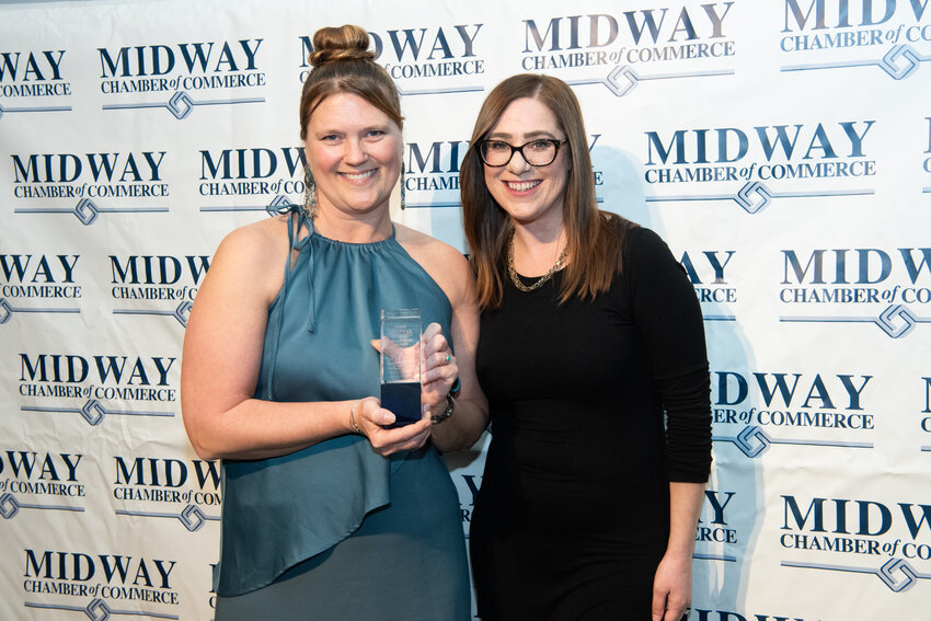 Jessie Higgins (right) of the Neighborhood Development Center congratulates Tesha M. Christensen on being named the 2025 Chamber Volunteer of the Year.