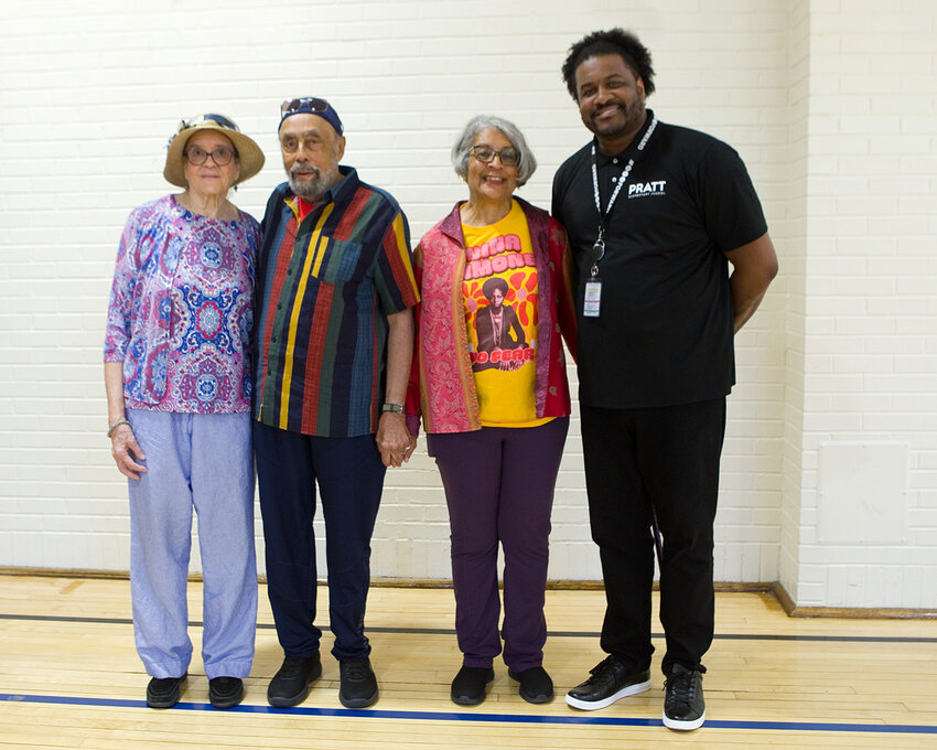 Pratt Elementary School Principal Justyn Burgess (right) celebrates with the Jackson family, Sharon Peters with husband, Melvin, (left) and Judith Claytor (center), granddaughters of Madison and Amy Jackson. Their story provides a springboard for Pratt students and staff to ask questions about race, and to learn about history and resilience in their own community.(Photo by Margie O’Loughlin)