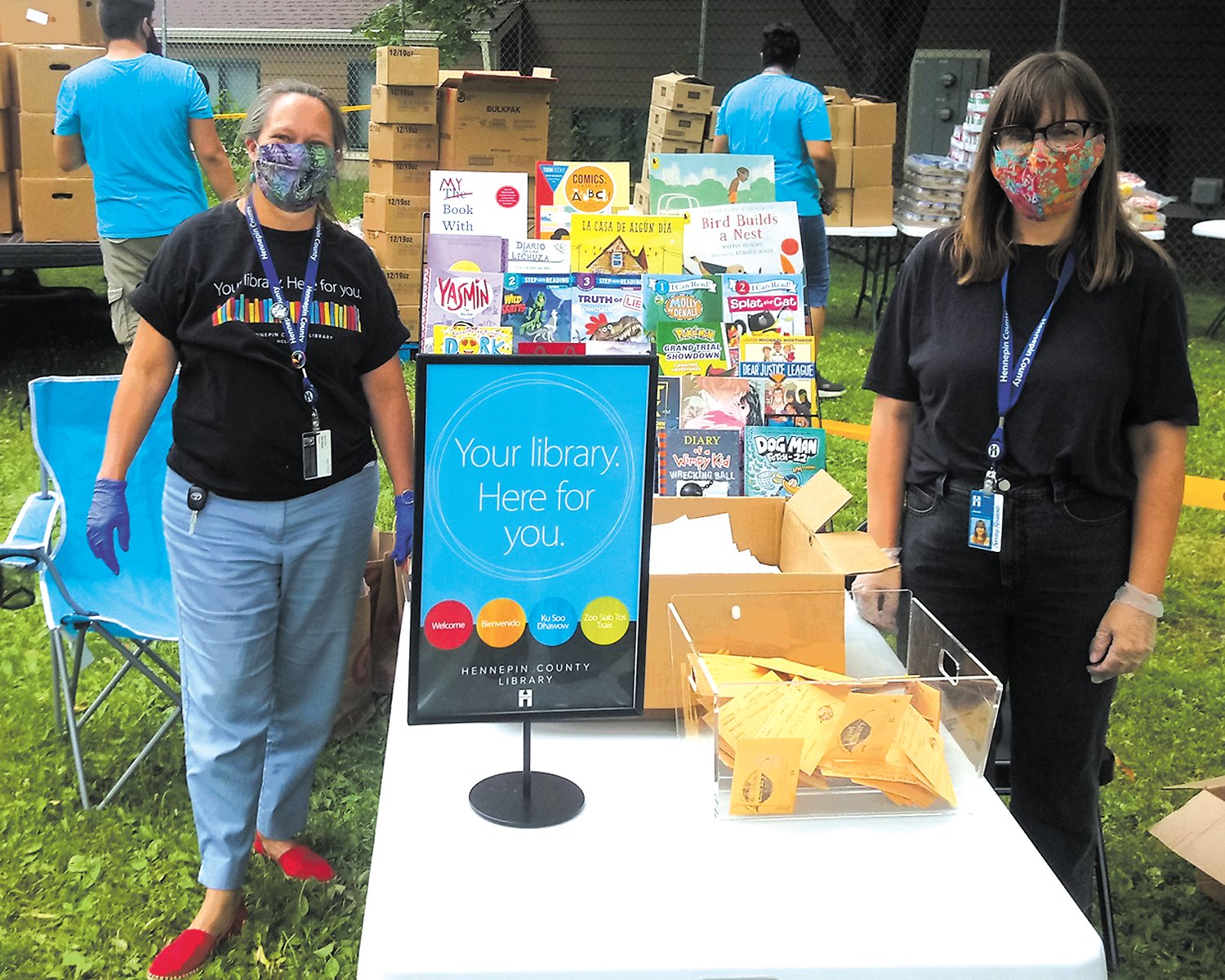 Nokomis Library staff members Lisa Stuart (left) and Jane Boss (right) discuss library resources and distribute free books to children at the bi-monthly events at Bossen Park Apartments. (Photo courtesy of NENA)