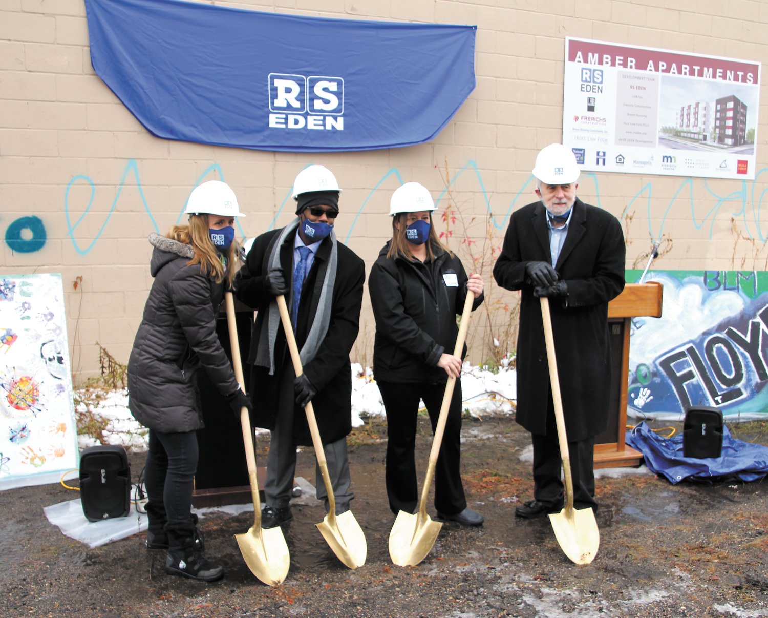Folks break ground for the five-story, 52,178-square-foot Amber Apartments on Wednesday, Oct. 21, 2020. Left to right are RS Eden President and CEO Caroline Hood, former RS Eden client Cletus Robinson, building namesake Amber Cain, and former RS Eden President Dan Cain. The 80-unit building on the one-acre site just north of Walgreens along Hiawatha will replace the Bell Laboratory building. There will be a 25-space parking lot and inside storage for bicycles. One third of the property will be green space along what planner hope will soon be the Minn Hi Line linear park. (Photo by Tesha M. Christensen)