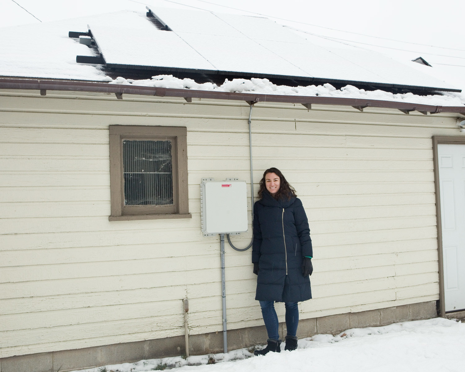 South Minneapolis homeowner Kelly Muellman installed solar panels on her garage in 2018, as a member of an earlier group of Twin Cities Solar United Neighbors. She said, "Being part of a co-op was great. Our neighbor group reviewed several bids from installers together, and chose the one we thought had the best reputation, warranty, and price." (Photo by Margie O’Loughlin)