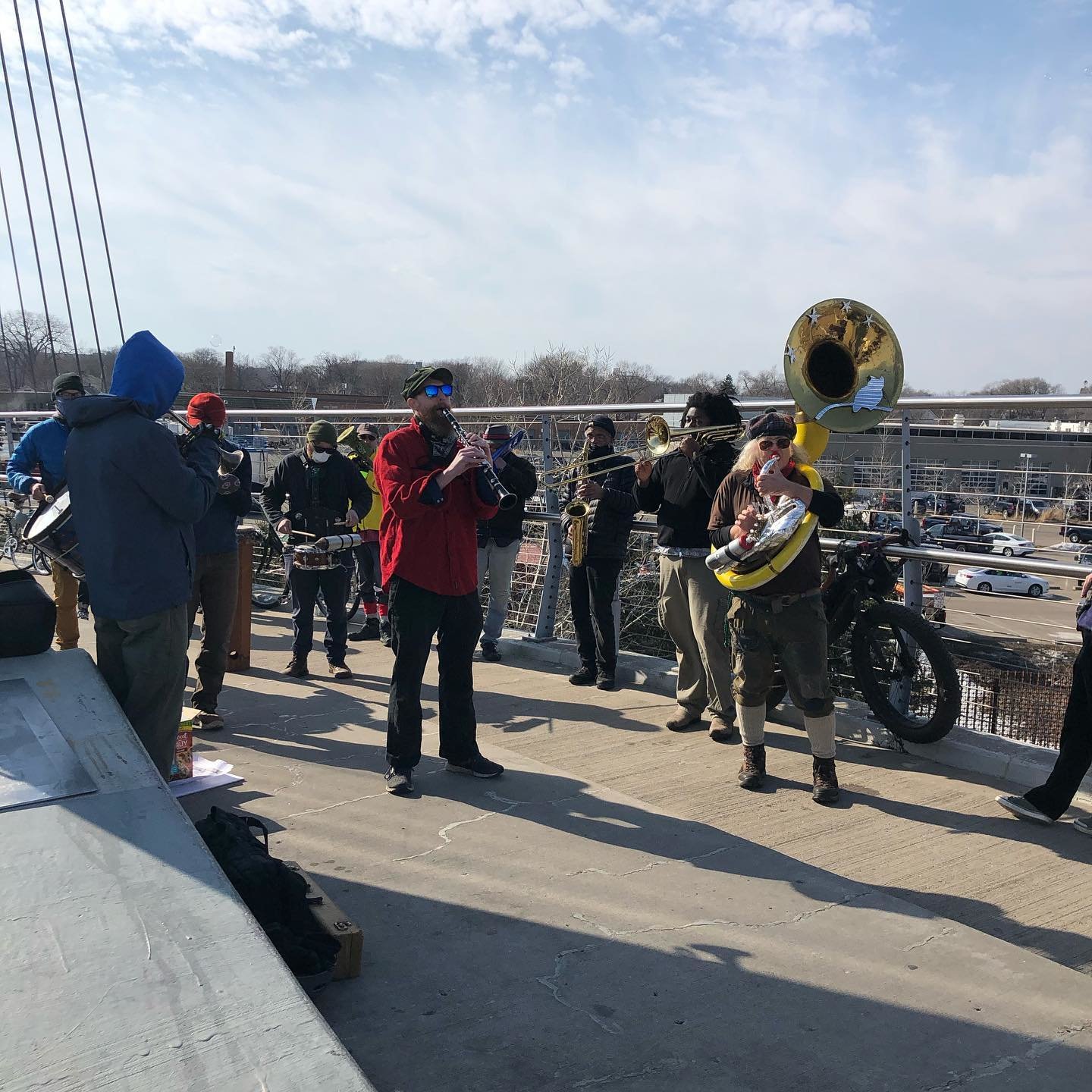 People rallied in support of the East Phillips Indoor Urban Farm on Sunday, March 7. They are standing on the Sabo Bridge overlooking the site.