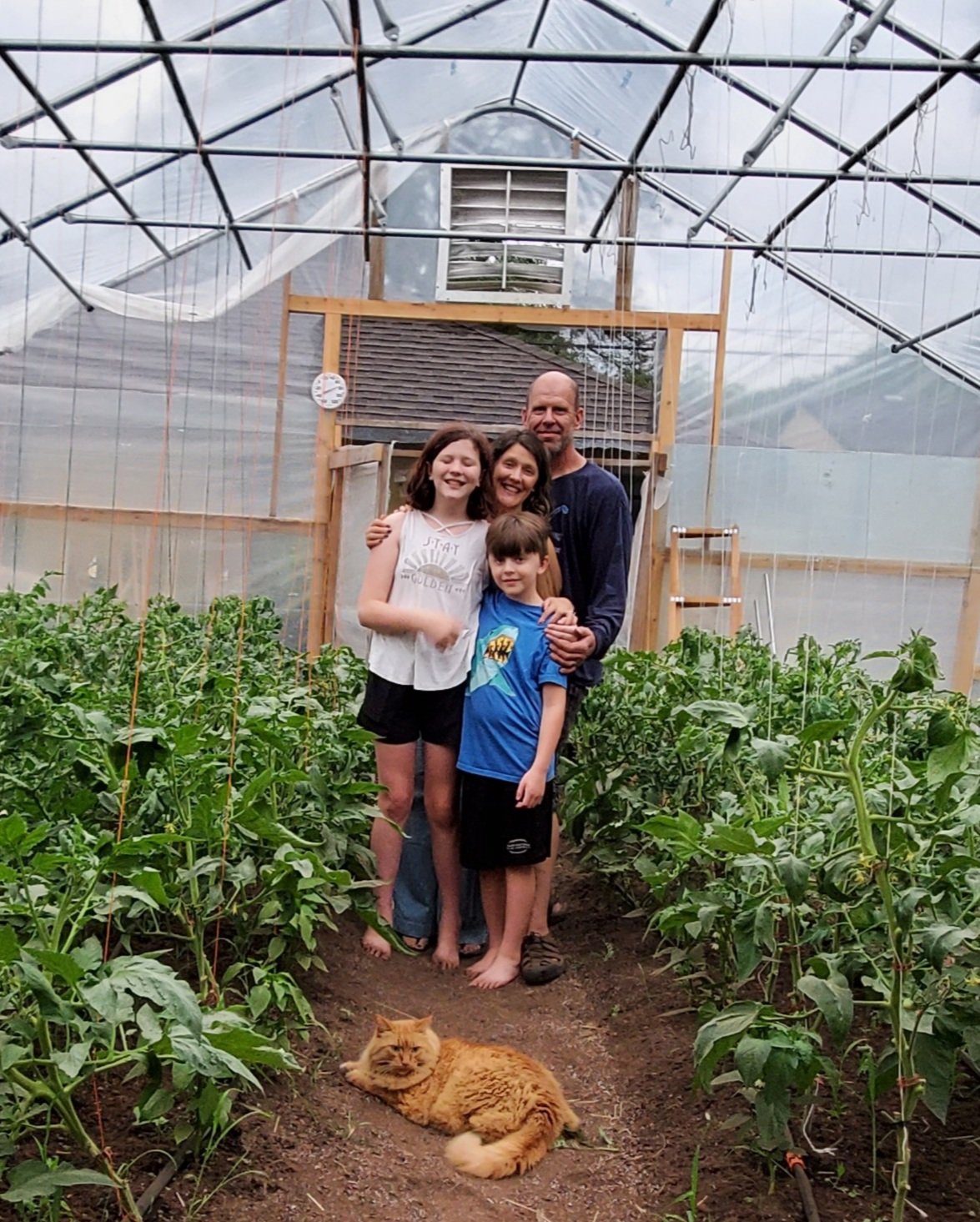 Gardening is a family passion for Longfellow residents David, Beth, Elsie (age 12) and Jack (age 9) Gray. Their latest project is a high-tunnel greenhouse and roadside stand south of Moon Palace Books. (Photo submitted)