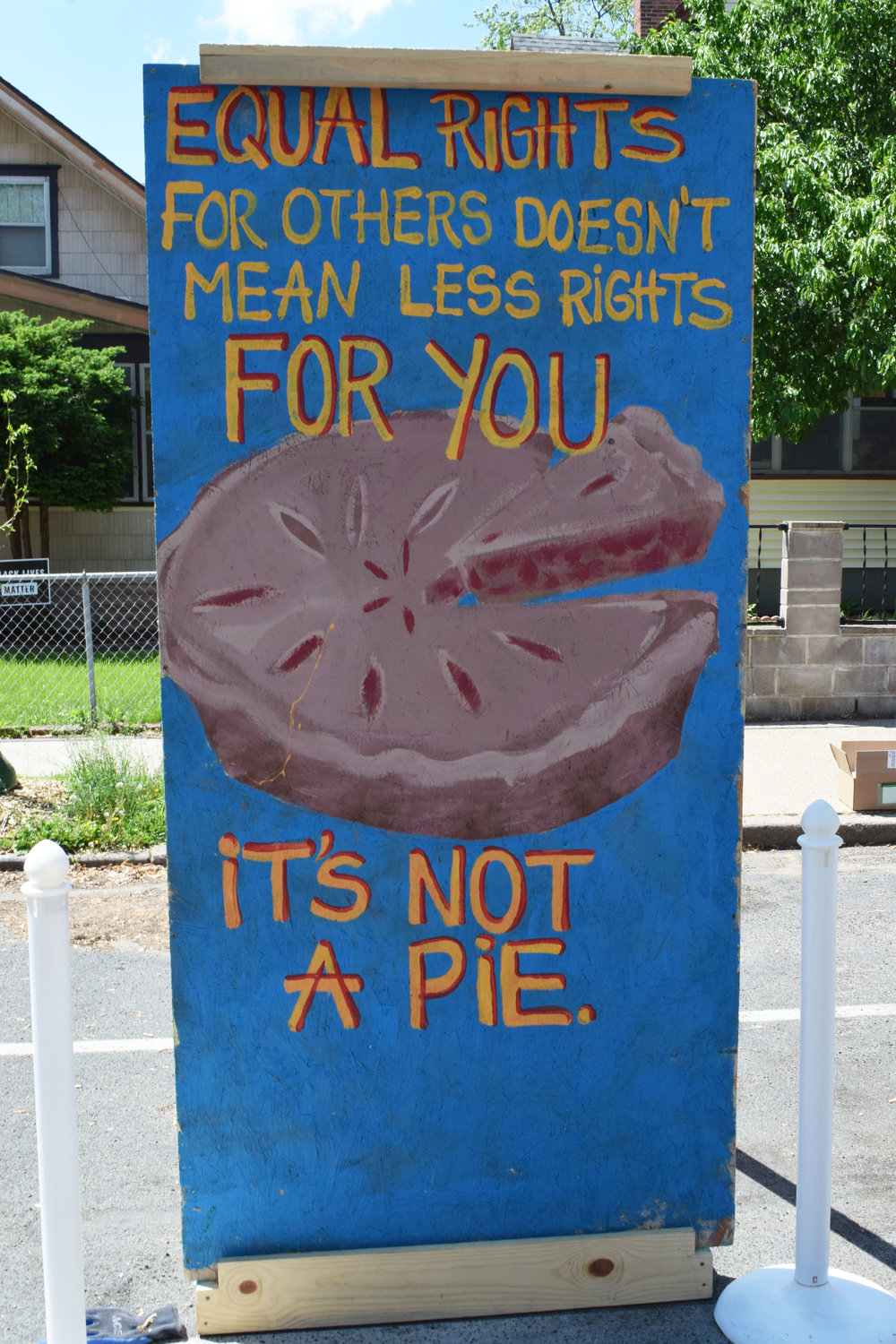 Plywood art mural reads “Equal rights for others doesn’t mean less rights for you. It’s not a pie.” Some of the plywood art murals collected since last year’s uprising line Chicago Ave. during the one-year celebration on May 25th. Save the Boards, Memorialize the Movement and the Minnesota African American Heritage Museum and Gallery sponsored the first public installation of these murals the previous weekend on May 22. More information is at memorializethemovement.com.