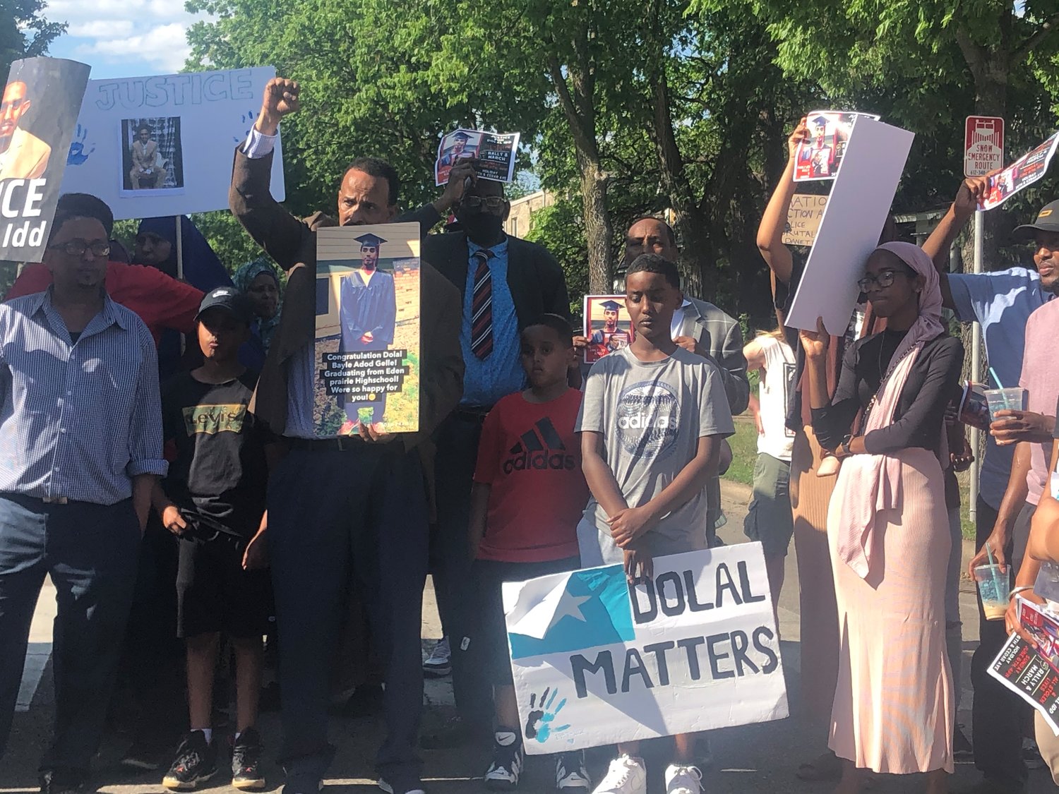 Bayle Gelle, Dolal Idd’s father (center left, with fist raised), stands with family members and supporters during a march on June 6, 2021 demanding answers into the killing of his son by Minneapolis police at the Holiday Station Store along Cedar Ave. (Photo by Jill Boogren)