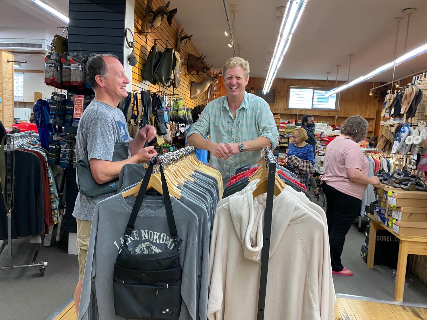 Nokomis Shoe Shop owner Steve Negaard (right) with Tre McClellan welcome folks into the store for the sidewalk sale, which moved instead after it rained on Saturday, Aug. 7. Negaard was delighted to see other business engaging in Crazy Days again. "As a guy who has been doing it for 45 years, it's so fun to see the neighborhood coming back alive," he said. Nokomis Shoes used to be located next to the bowling alley (formerly Skylanes, now Town Hall) and items filled the sidewalk in front of the bowling alley. "I remember being a kid in high school and dreading working the long days in the heat," said Negaard.