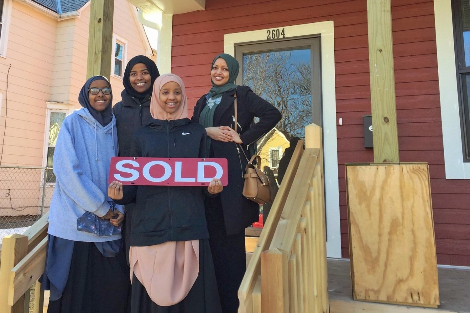 New homeowners display a SOLD sign.  (Photo submitted)