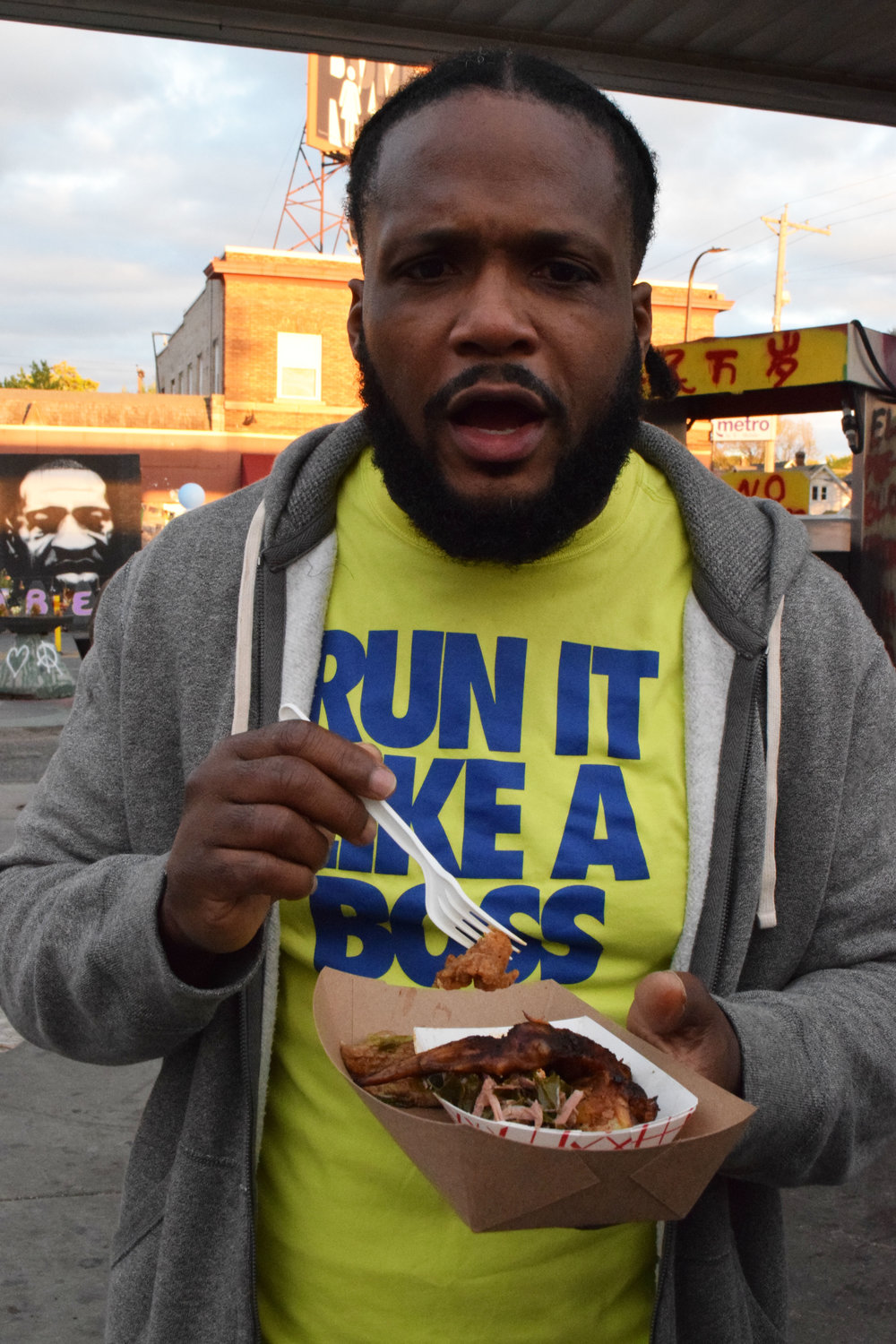 Darryl Green, whose spoken word can be found under Chatterlac on YouTube, tucks into a meal provided by The Igloo Café. House of Gristle and Sisters Camelot also provide free meals at the event.