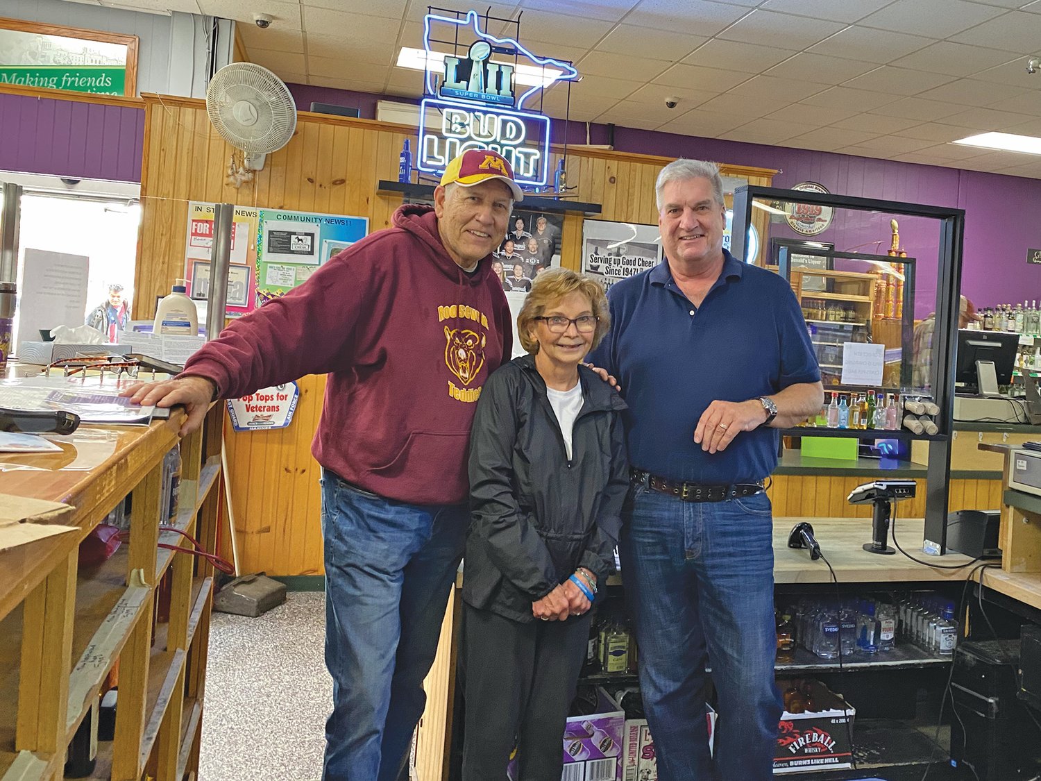 Lee and Janet Nelson stand with Mark McDonald at McDonald's Liquor store along 34th Ave., where the couple met while both were working at what was then a grocery store.